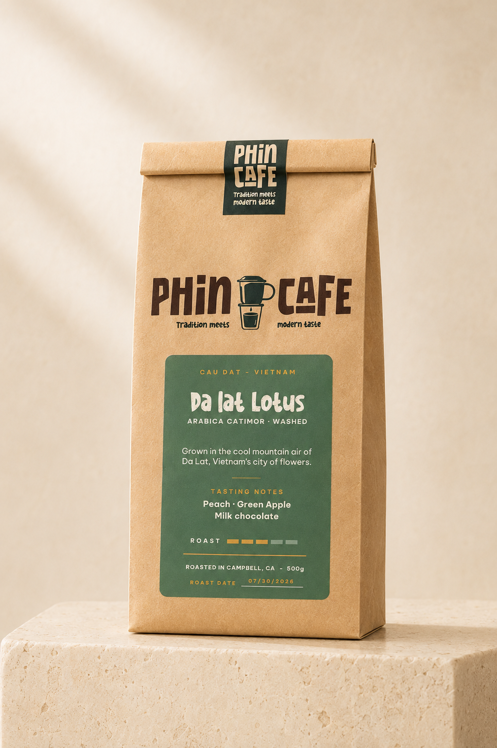 Da Lat Lotus — 500g kraft bag of Phin Cafe washed arabica coffee with a green label, on a stone plinth