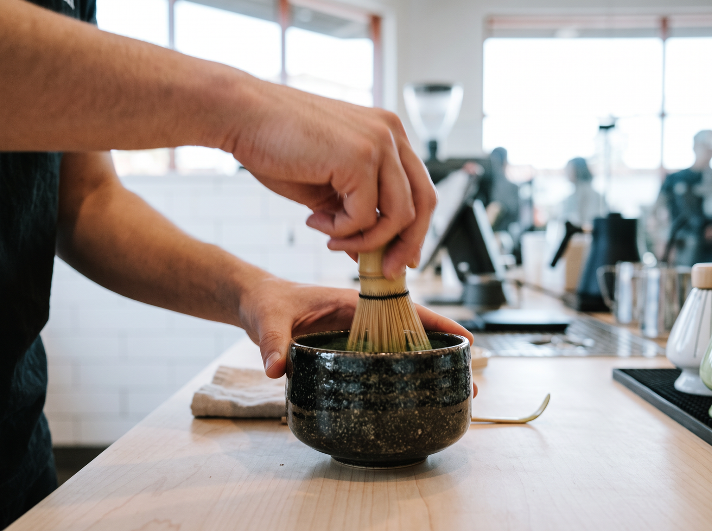 Whisking matcha with a chasen, foam forming