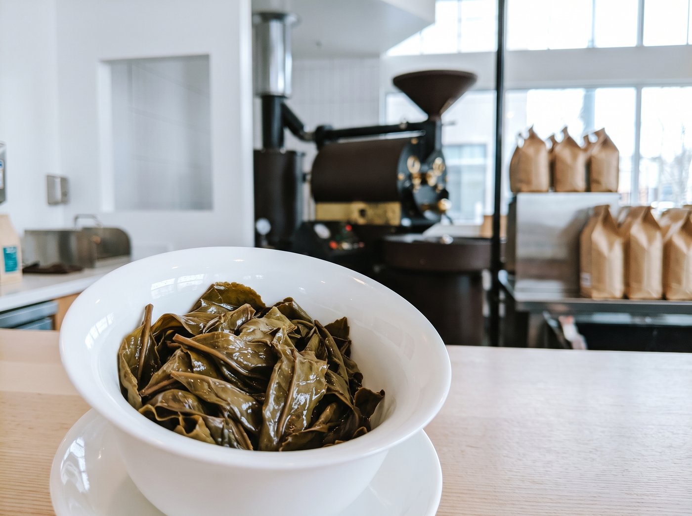 Spent oolong leaves unfurled in an emptied gaiwan