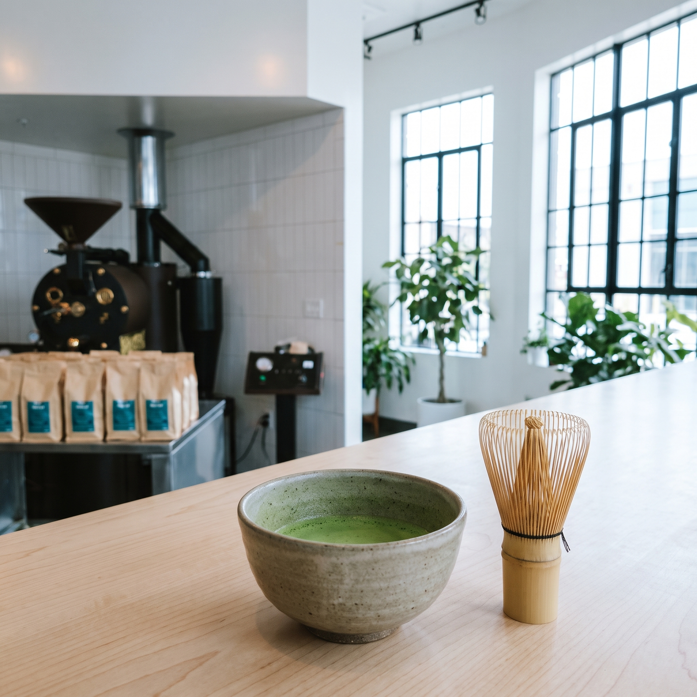 A bowl of whisked matcha and a chasen on the counter at Phin Cafe